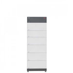 A tall, rectangular BYD Battery-Box unit in gray and white features a modular, high-voltage design with multiple stacked sections and a small red BYD logo at the top right corner.