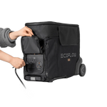 A person opens a side compartment on a black Ecoflow Delta Pro wheeled bag, revealing power outlets and connecting a cable to the 3600W output solar generator inside.
