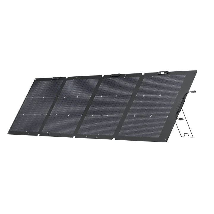 An Ecoflow portable, foldable waterproof solar panel with four connected black sections is propped up at an angle using built-in stands.
