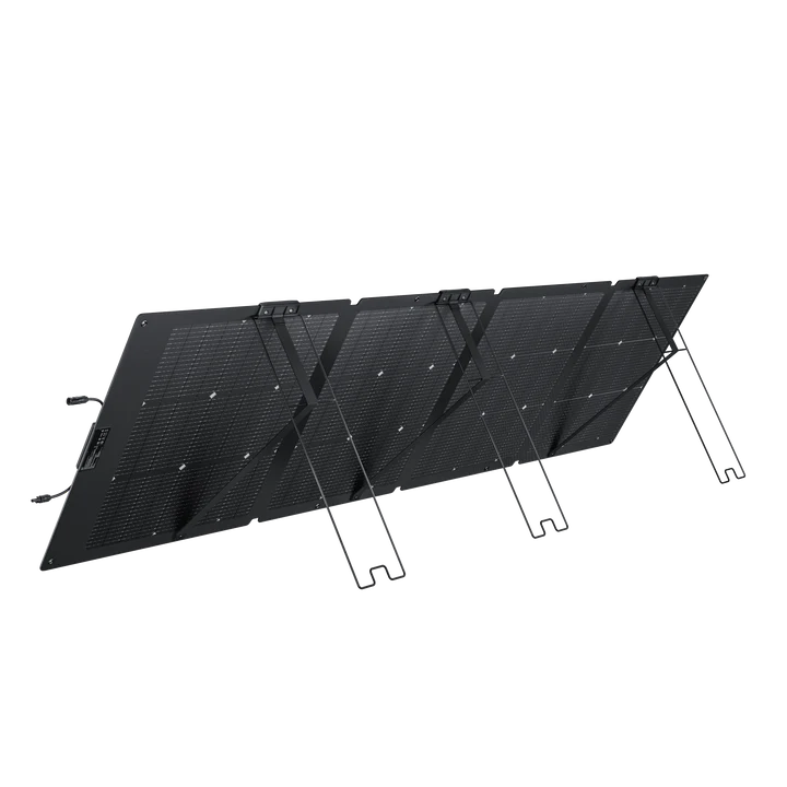 An Ecoflow black portable waterproof solar panel is unfolded and propped up at an angle with built-in stands, displaying its grid of solar cells for outdoor use.