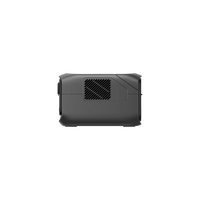 Side view of the Ecoflow compact black electronic device with a vented grille, rounded edges, smooth matte finish, and expandable capacity, isolated on a transparent background.
