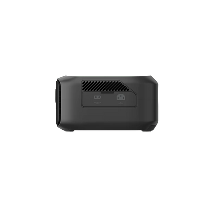 A black rectangular Ecoflow device is shown from the back, featuring ventilation slats and two ports. Its compact, portable design with advanced X-GaNPower technology is set against a plain white background.