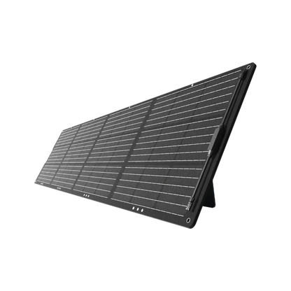 A portable, foldable Mango Power solar panel with multiple segments is propped up at an angle for optimal sunlight exposure, ideal for charging your devices, set against a plain white background.