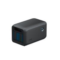 The Anker SOLIX BP1000X is a black rectangular device with a textured surface, blue-lit filter grille, and circular side power button; its an expansion battery offering reliable use for up to 10 years.