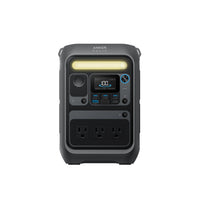 A black Anker 288Wh power station with a digital display, dual three-prong outlets, multiple USB ports, control buttons, and a top LED light bar is shown in a portable design on a white background.