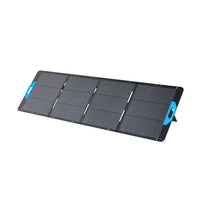 The Anker portable, foldable solar panel features four black rectangular sections, blue handles at both ends, a built-in stand, IP67 waterproof protection, and is shown against a white background.