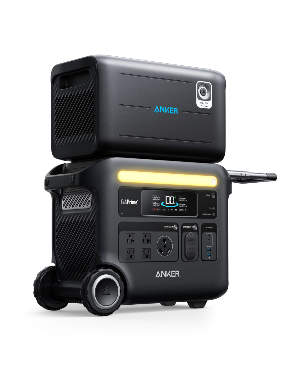 A black Anker portable power station with wheels, various outlets, a digital display, solar input, and an extra battery pack stacked on top is shown against a white background.
